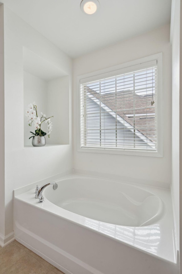 bathroom featuring a bath and tile patterned flooring