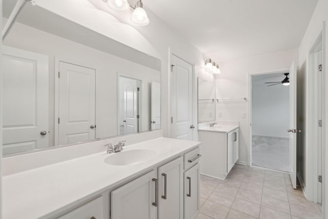 bathroom with two vanities, tile patterned floors, and a ceiling fan