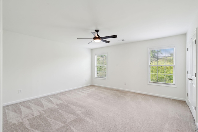empty room with light carpet, baseboards, and visible vents