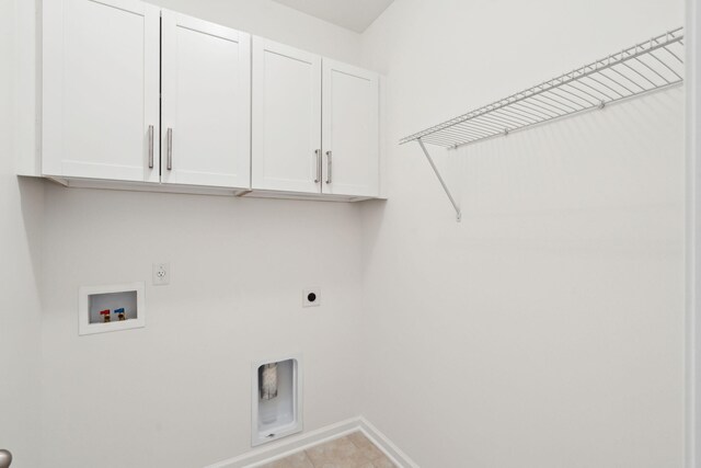 laundry room featuring cabinet space, hookup for an electric dryer, hookup for a washing machine, tile patterned flooring, and baseboards