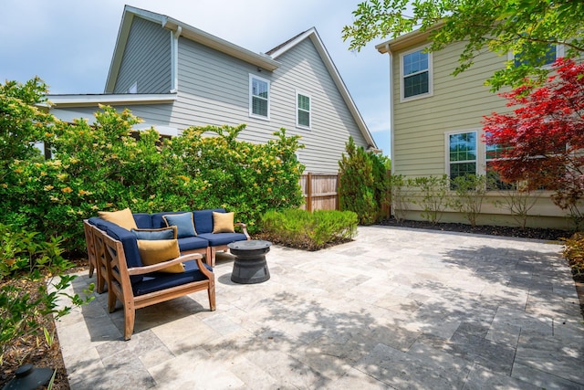 view of patio featuring outdoor lounge area and fence