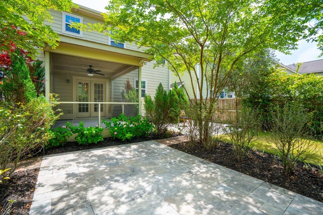 view of patio / terrace with ceiling fan and fence