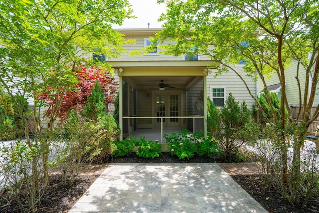 rear view of house with ceiling fan and french doors