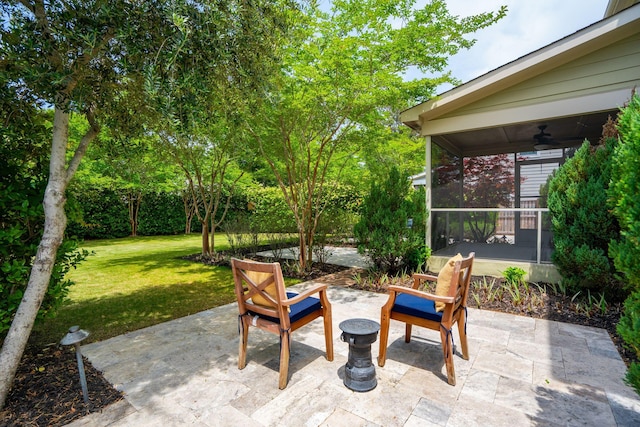 view of patio with ceiling fan and a sunroom