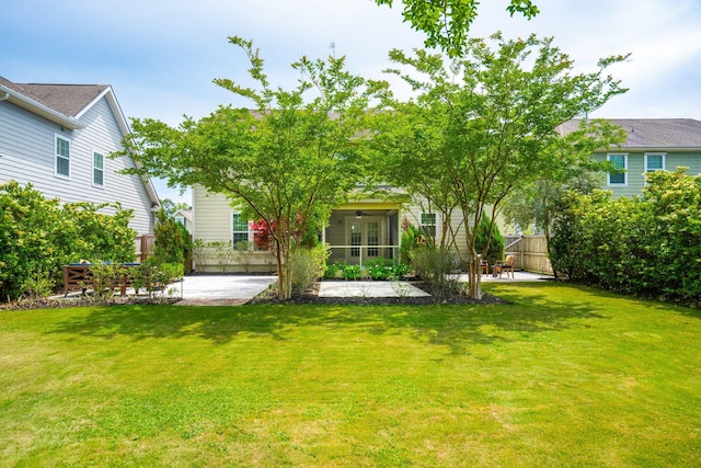 view of yard featuring fence, a patio, french doors, and a ceiling fan