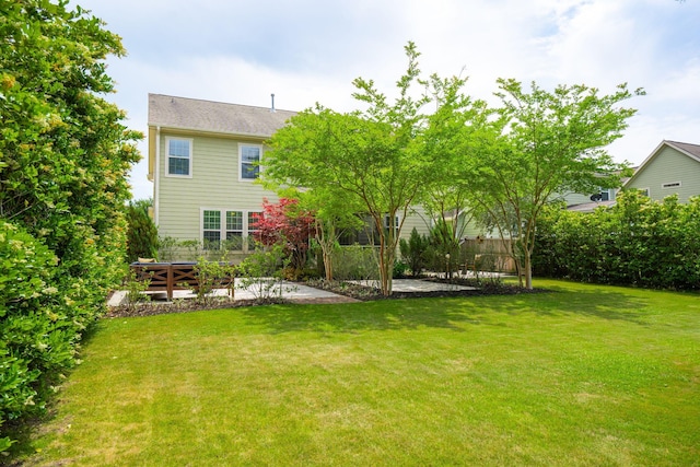 rear view of property featuring a yard