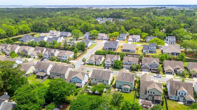 bird's eye view featuring a forest view and a residential view