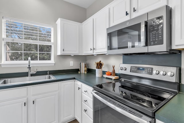 kitchen featuring white cabinetry, stainless steel appliances, and sink