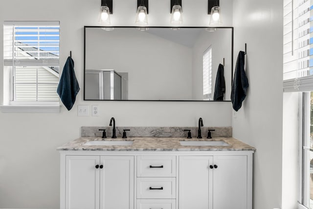 bathroom with walk in shower and vanity