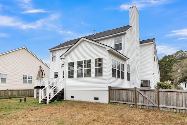 back of property featuring a yard, central AC, and a deck