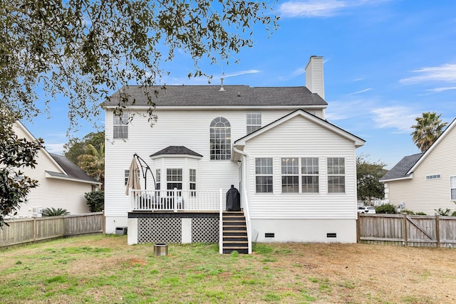 back of house with a wooden deck and a yard