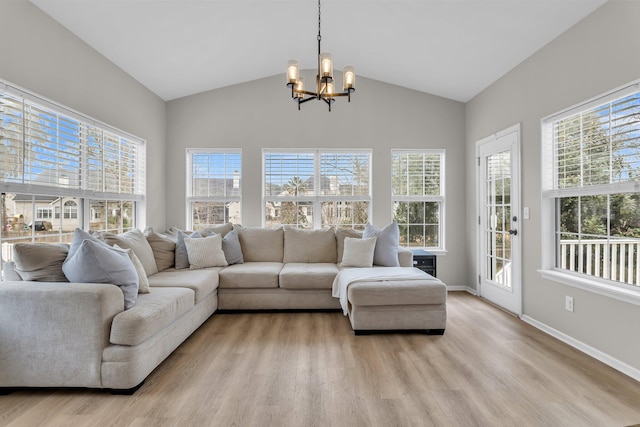 sunroom with lofted ceiling and a chandelier