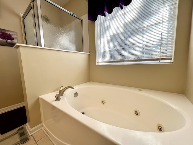 bathroom featuring tile patterned flooring and shower with separate bathtub