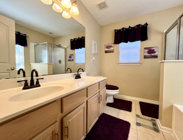 bathroom with toilet, a shower with door, vanity, and tile patterned flooring