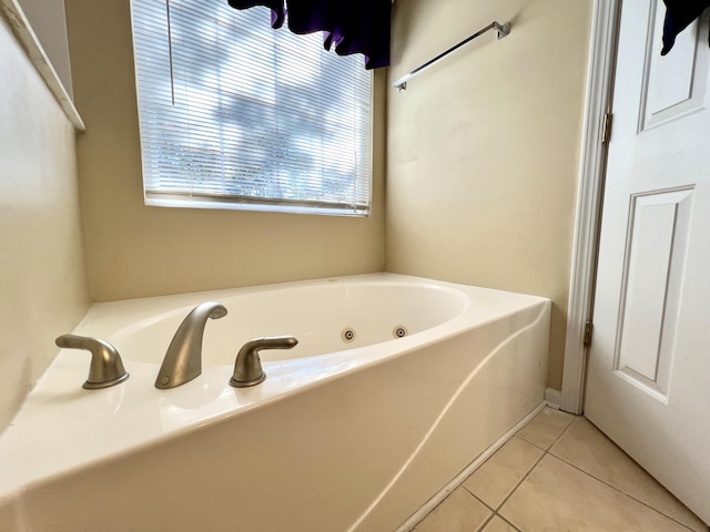 bathroom with a tub to relax in and tile patterned flooring