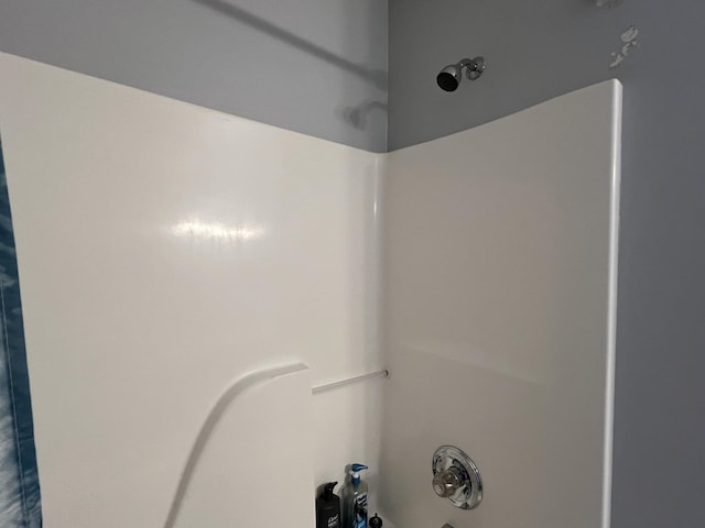 interior details featuring tub / shower combination