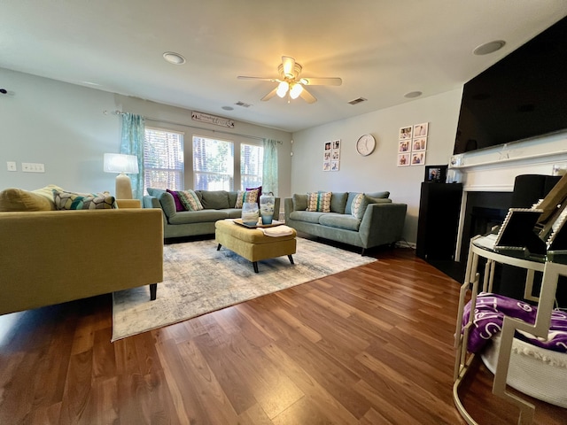 living room with hardwood / wood-style floors and ceiling fan