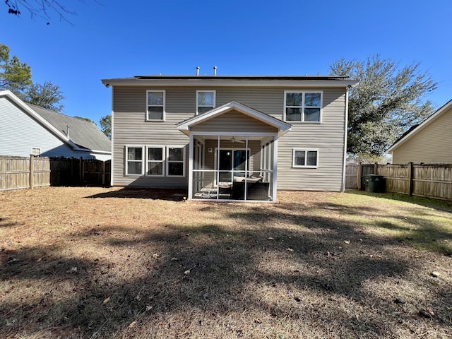 back of house featuring a sunroom and a yard