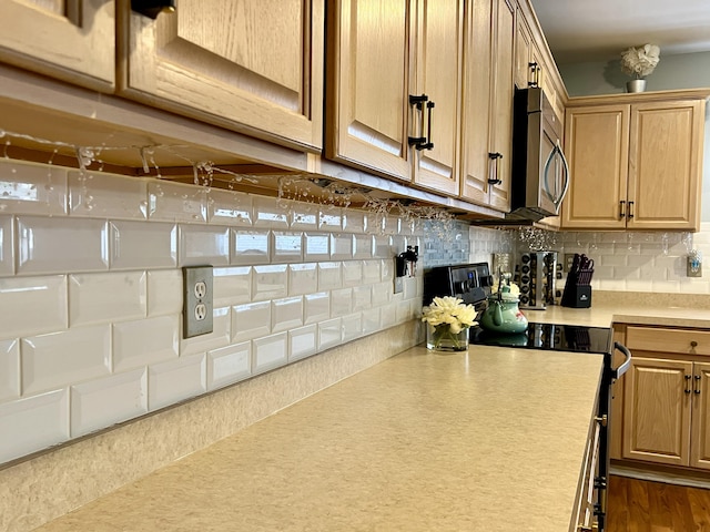 kitchen with backsplash and electric range