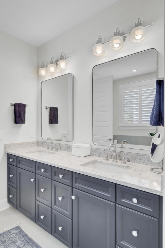 bathroom featuring double vanity, a sink, and tile patterned floors