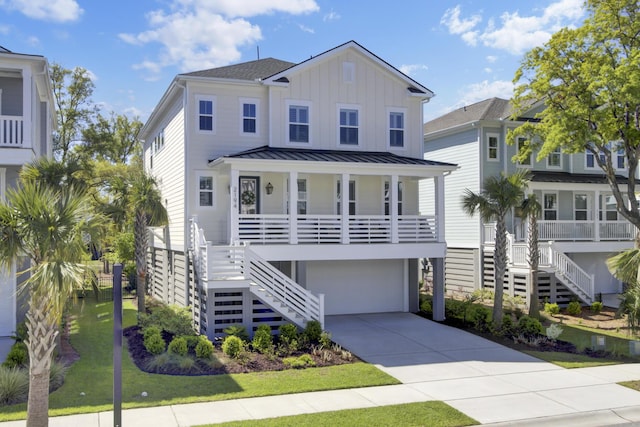 beach home featuring a porch, a standing seam roof, stairs, driveway, and board and batten siding