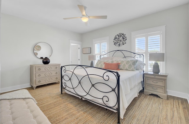 bedroom featuring baseboards, a ceiling fan, and light wood finished floors