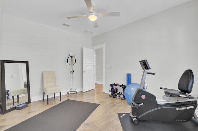 workout area with baseboards, visible vents, wood finished floors, and a ceiling fan