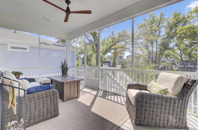 sunroom featuring ceiling fan and a wealth of natural light