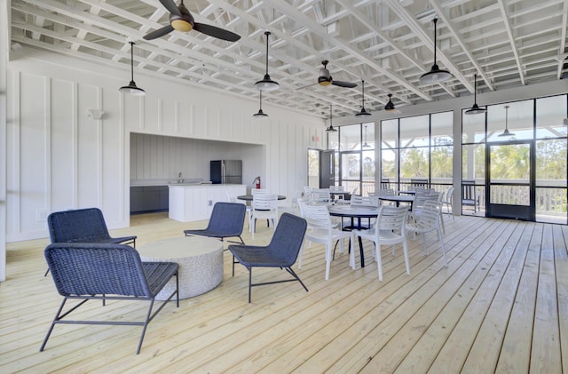 wooden deck featuring a ceiling fan and outdoor dining area