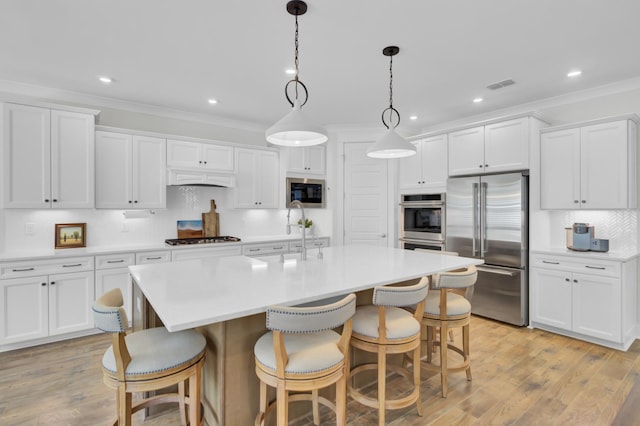 kitchen featuring decorative backsplash, white cabinets, built in appliances, visible vents, and ornamental molding
