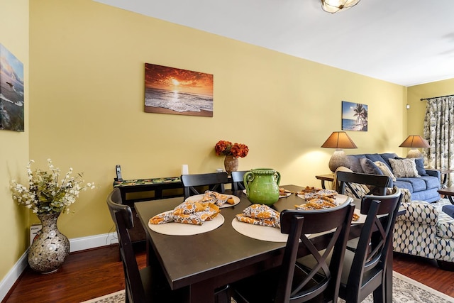 dining space with dark hardwood / wood-style floors