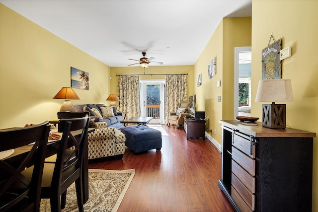 living room with dark hardwood / wood-style floors and ceiling fan