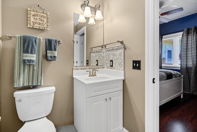 bathroom featuring vanity, hardwood / wood-style flooring, and toilet