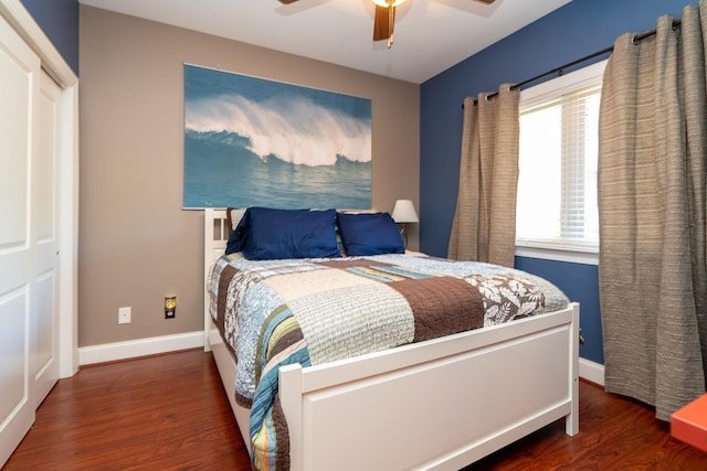 bedroom featuring a closet, dark hardwood / wood-style floors, and ceiling fan