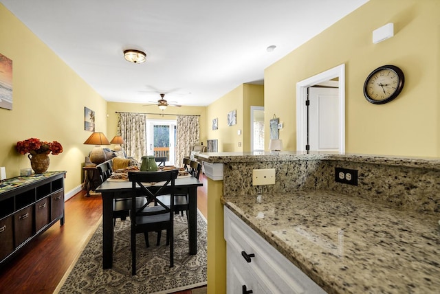 dining room with dark hardwood / wood-style floors and ceiling fan