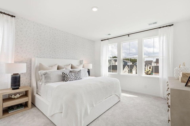 bedroom featuring light carpet