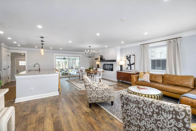 1762 James Loop Rd, Manning, SC 29102 - living room with crown molding, recessed lighting, a chandelier, dark wood-style flooring, and a fireplace