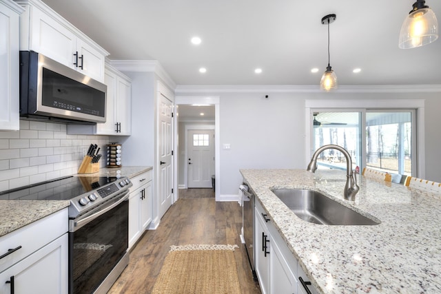 1762 James Loop Rd, Manning, SC 29102 - kitchen with appliances with stainless steel finishes, crown molding, a sink, tasteful backsplash, and dark wood-type flooring