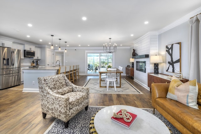 1762 James Loop Rd, Manning, SC 29102 - living area with dark wood finished floors, crown molding, recessed lighting, baseboards, and a chandelier