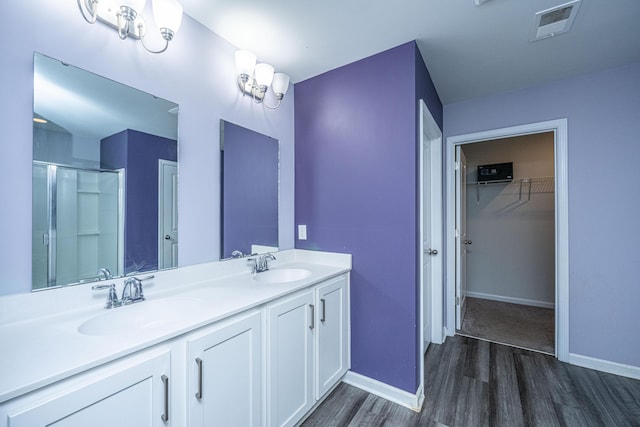 431 Buckhannon Ln, Moncks Corner, SC 29461 - full bathroom featuring wood finished floors, a stall shower, double vanity, and a spacious closet