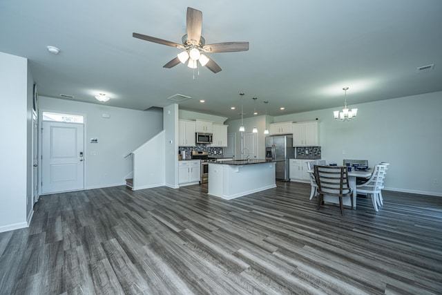 431 Buckhannon Ln, Moncks Corner, SC 29461 - kitchen featuring stainless steel appliances, open floor plan, dark countertops, a chandelier, and tasteful backsplash