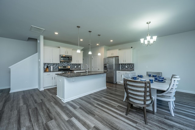 431 Buckhannon Ln, Moncks Corner, SC 29461 - kitchen featuring stainless steel appliances, tasteful backsplash, a center island with sink, dark wood-type flooring, and recessed lighting