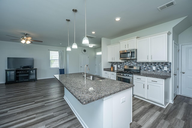 431 Buckhannon Ln, Moncks Corner, SC 29461 - kitchen featuring appliances with stainless steel finishes, dark wood finished floors, a center island with sink, white cabinets, and recessed lighting