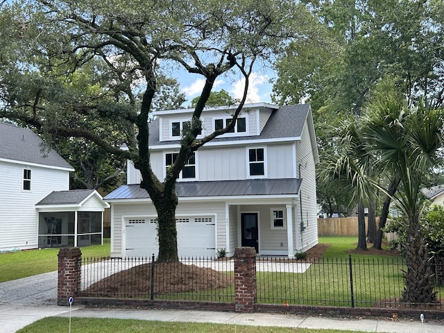 641 Magnolia Rd, Charleston, SC 29407 - view of front of property with a sunroom, a garage, driveway, a fenced front yard, and board and batten siding