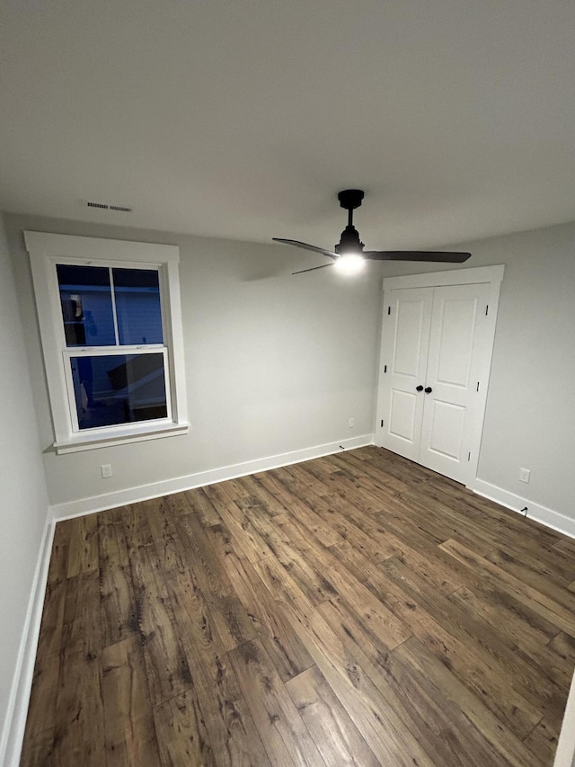 641 Magnolia Rd, Charleston, SC 29407 - unfurnished bedroom featuring dark wood-style flooring, a ceiling fan, and a closet