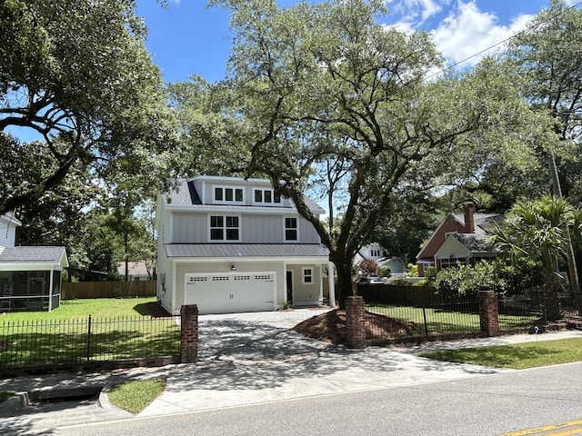 641 Magnolia Rd, Charleston, SC 29407 - view of front of property with a front yard, a garage, concrete driveway, a metal roof, and a standing seam roof
