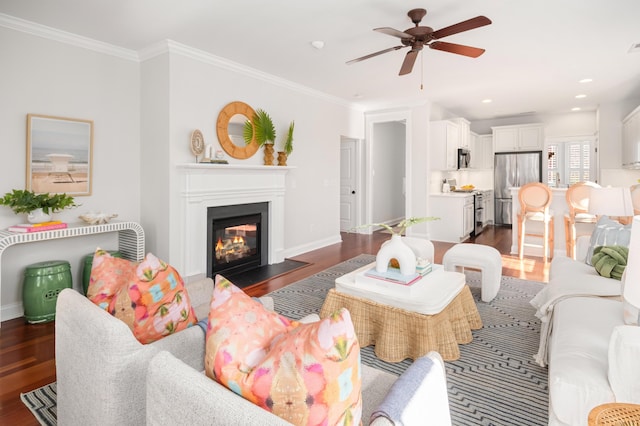 living room featuring a ceiling fan, crown molding, and dark wood-style floors