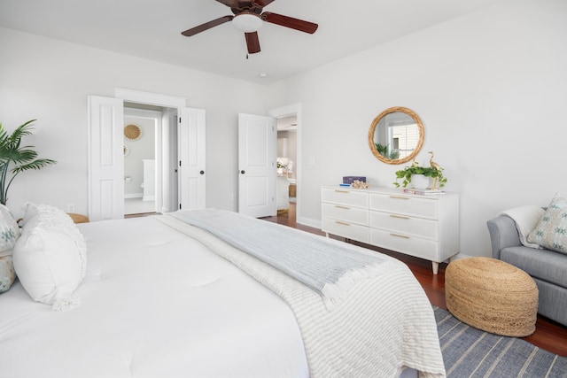 bedroom featuring a ceiling fan, wood finished floors, and ensuite bathroom