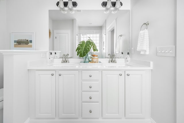 bathroom with a sink and double vanity