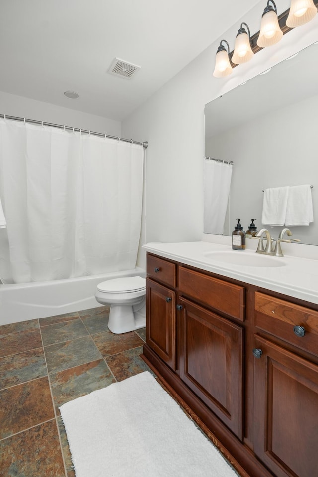 bathroom with visible vents, toilet, vanity, and shower / bath combination with curtain